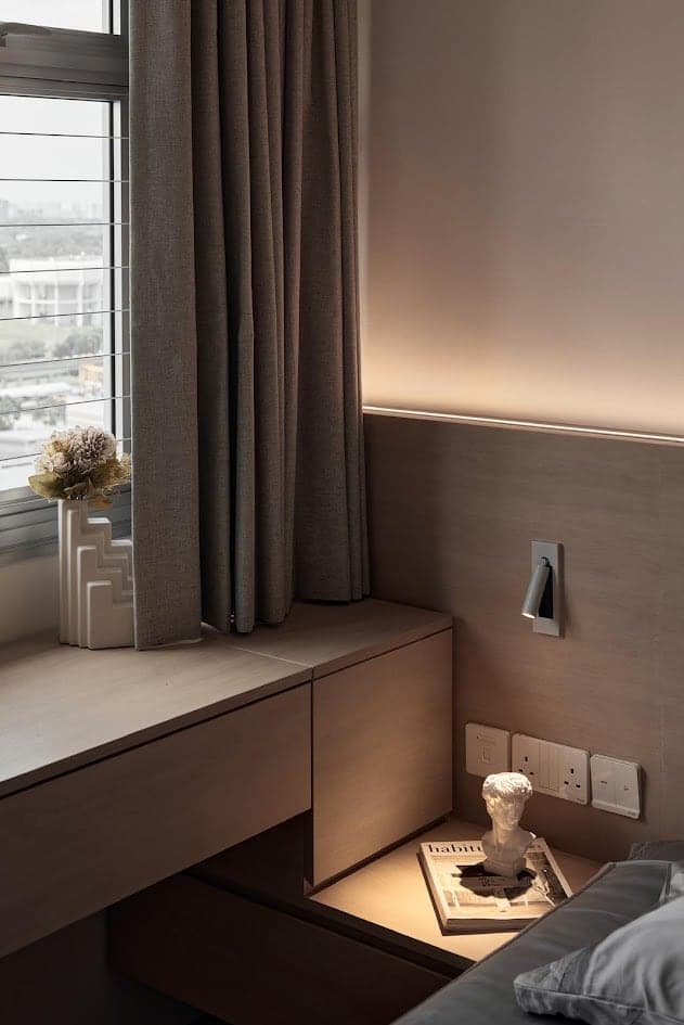 Bedroom study nook by the window with warm concealed light under the wall shelf
